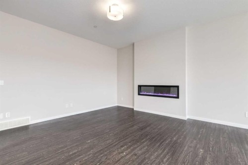 70 Howse Common Ne, Calgary, AB - Indoor Photo Showing Other Room With Fireplace