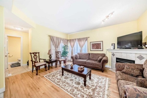 187 Bridlewood View Sw, Calgary, AB - Indoor Photo Showing Living Room With Fireplace