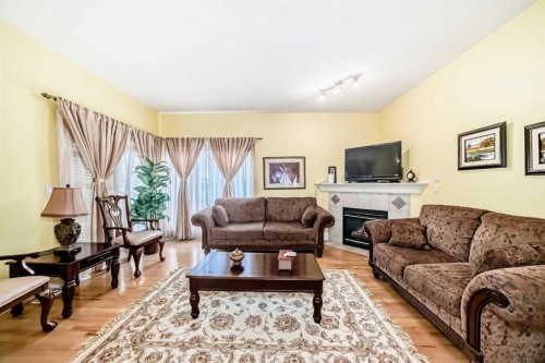 187 Bridlewood View Sw, Calgary, AB - Indoor Photo Showing Living Room With Fireplace