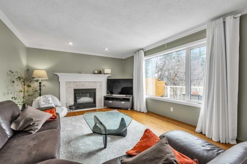 28 Woodpark Close Sw, Calgary, AB - Indoor Photo Showing Living Room With Fireplace