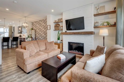 146 Magnolia Square Se, Calgary, AB - Indoor Photo Showing Living Room With Fireplace