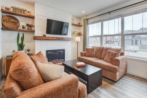 146 Magnolia Square Se, Calgary, AB - Indoor Photo Showing Living Room With Fireplace