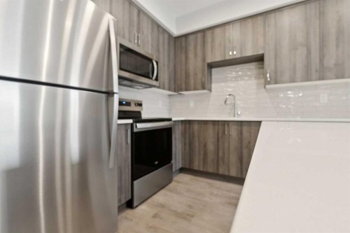 103-655 Shawnee Square Sw, Calgary, AB - Indoor Photo Showing Kitchen With Stainless Steel Kitchen With Upgraded Kitchen