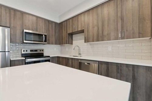 103-655 Shawnee Square Sw, Calgary, AB - Indoor Photo Showing Kitchen With Stainless Steel Kitchen With Upgraded Kitchen