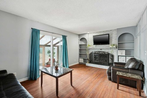 13811 Deer Run Boulevard Se, Calgary, AB - Indoor Photo Showing Living Room With Fireplace