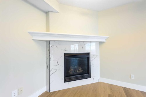 42 Royal Crest Point Nw, Calgary, AB - Indoor Photo Showing Other Room With Fireplace