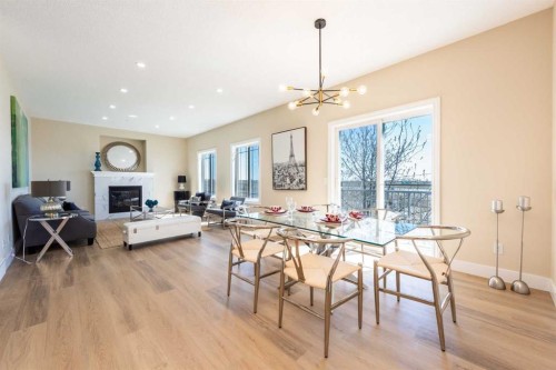 42 Royal Crest Point Nw, Calgary, AB - Indoor Photo Showing Dining Room With Fireplace