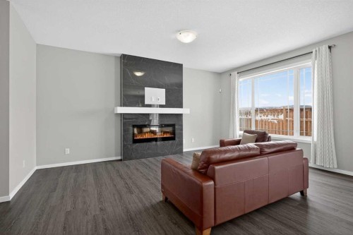 154 Yorkstone Way Sw, Calgary, AB - Indoor Photo Showing Living Room With Fireplace