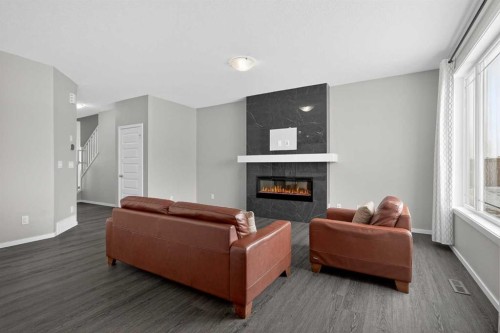 154 Yorkstone Way Sw, Calgary, AB - Indoor Photo Showing Living Room With Fireplace