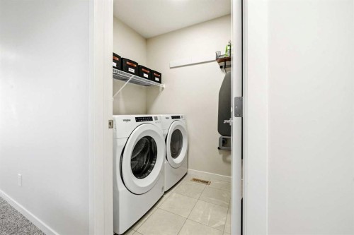 17 Precedence Glen, Cochrane, AB - Indoor Photo Showing Laundry Room