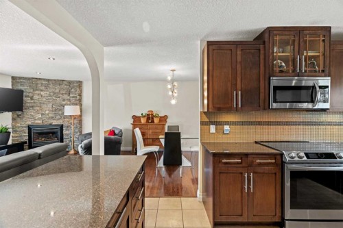 10311 Wapiti Drive Se, Calgary, AB - Indoor Photo Showing Kitchen With Fireplace