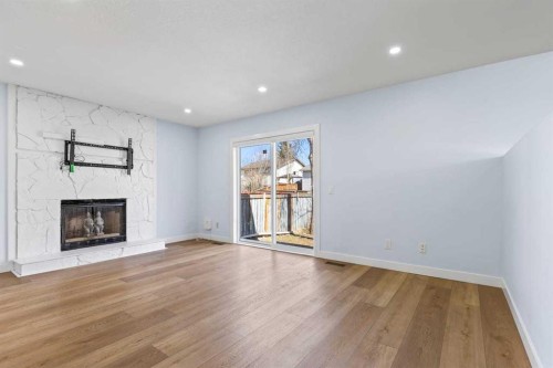 55 Whitehaven Crescent Ne, Calgary, AB - Indoor Photo Showing Living Room With Fireplace