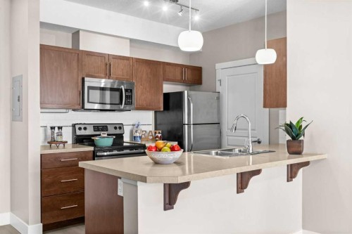 407-2300 Evanston Square Nw, Calgary, AB - Indoor Photo Showing Kitchen With Stainless Steel Kitchen With Double Sink With Upgraded Kitchen