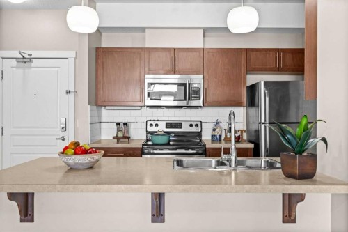 407-2300 Evanston Square Nw, Calgary, AB - Indoor Photo Showing Kitchen With Stainless Steel Kitchen With Double Sink With Upgraded Kitchen