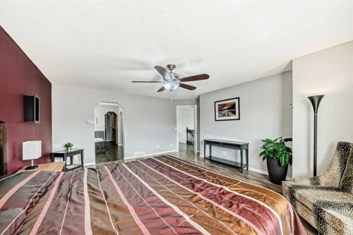 65 Morningside Circle Sw, Airdrie, AB - Indoor Photo Showing Bedroom With Fireplace