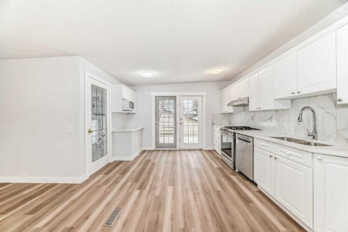 307 Huntridge Road Ne, Calgary, AB - Indoor Photo Showing Kitchen With Double Sink