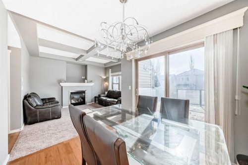 136 Sage Valley Drive Nw, Calgary, AB - Indoor Photo Showing Dining Room With Fireplace