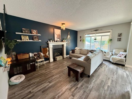607 Montgomery Close Se, High River, AB - Indoor Photo Showing Living Room With Fireplace