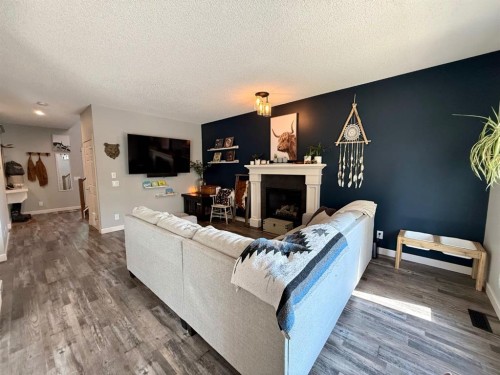 607 Montgomery Close Se, High River, AB - Indoor Photo Showing Living Room With Fireplace