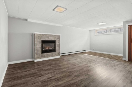 67 Hooke Road Sw, Calgary, AB - Indoor With Fireplace