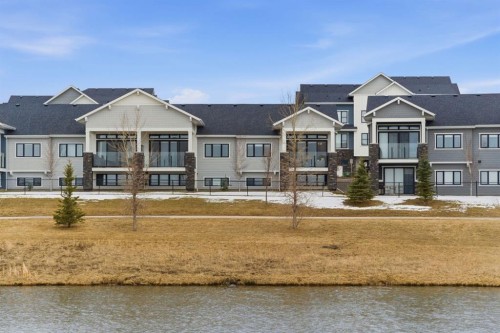 408 Crestridge Common Sw, Calgary, AB - Outdoor With Body Of Water With Deck Patio Veranda With Facade