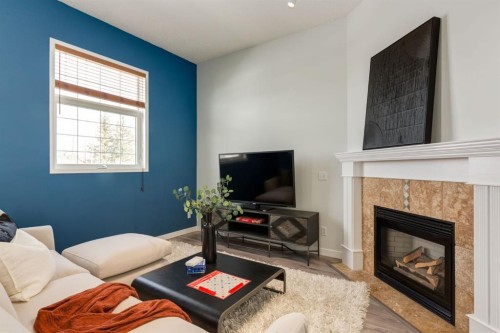 82 Hidden Ridge View Nw, Calgary, AB - Indoor Photo Showing Living Room With Fireplace