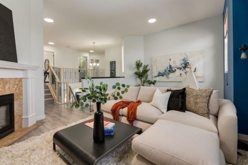 82 Hidden Ridge View Nw, Calgary, AB - Indoor Photo Showing Living Room With Fireplace