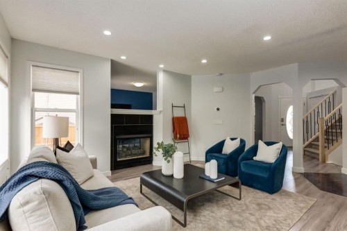 82 Hidden Ridge View Nw, Calgary, AB - Indoor Photo Showing Living Room With Fireplace
