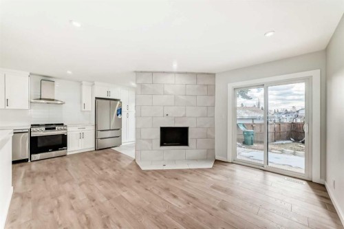 5173 Whitestone Road Ne, Calgary, AB - Indoor Photo Showing Kitchen With Fireplace With Stainless Steel Kitchen