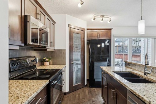 524 Cranston Drive Se, Calgary, AB - Indoor Photo Showing Kitchen With Double Sink