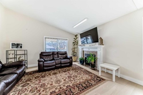 7165 California Boulevard Ne, Calgary, AB - Indoor Photo Showing Living Room With Fireplace