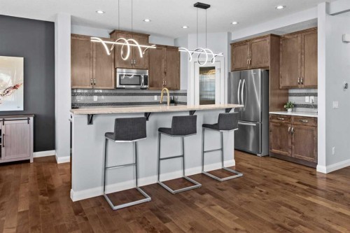 100 Kinniburgh Gardens, Chestermere, AB - Indoor Photo Showing Kitchen With Stainless Steel Kitchen With Upgraded Kitchen