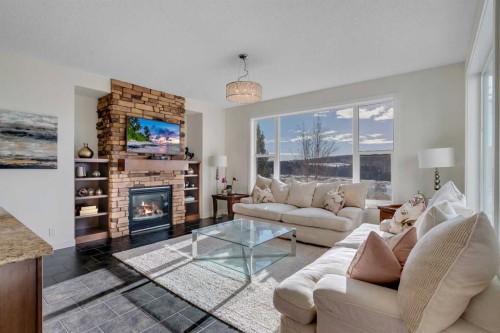 287 Sunset View, Cochrane, AB - Indoor Photo Showing Living Room With Fireplace