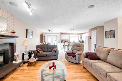 51 Bermondsey Place Nw, Calgary, AB - Indoor Photo Showing Living Room With Fireplace