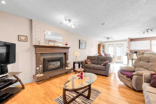 51 Bermondsey Place Nw, Calgary, AB - Indoor Photo Showing Living Room With Fireplace