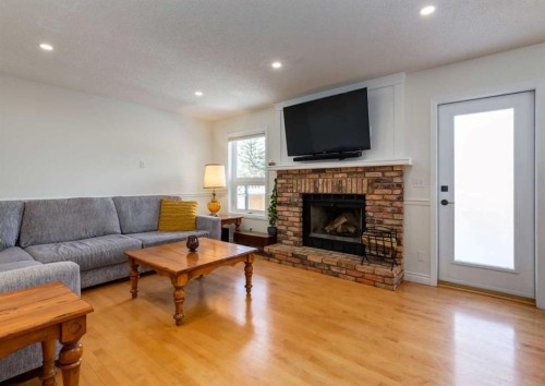 109 Sundown Place Se, Calgary, AB - Indoor Photo Showing Living Room With Fireplace