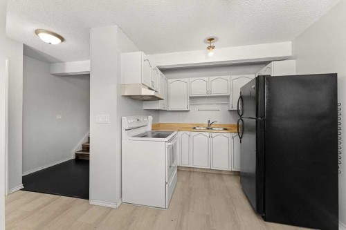 56-5520 1 Avenue Se, Calgary, AB - Indoor Photo Showing Kitchen With Double Sink