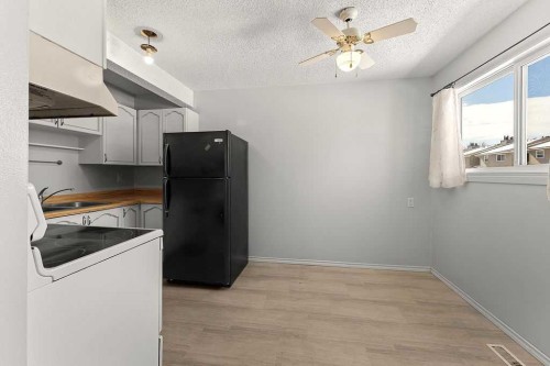 56-5520 1 Avenue Se, Calgary, AB - Indoor Photo Showing Kitchen With Double Sink