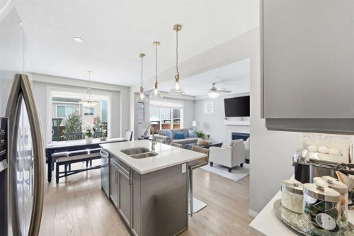 134 Windrow Link Sw, Airdrie, AB - Indoor Photo Showing Kitchen With Fireplace With Double Sink With Upgraded Kitchen