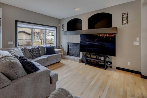 168 Sunset View, Cochrane, AB - Indoor Photo Showing Living Room With Fireplace