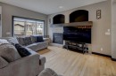 168 Sunset View, Cochrane, AB  - Indoor Photo Showing Living Room With Fireplace 