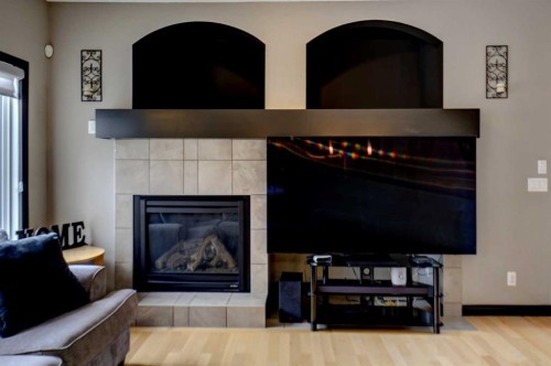 168 Sunset View, Cochrane, AB - Indoor Photo Showing Living Room With Fireplace