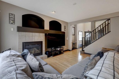 168 Sunset View, Cochrane, AB - Indoor Photo Showing Living Room With Fireplace