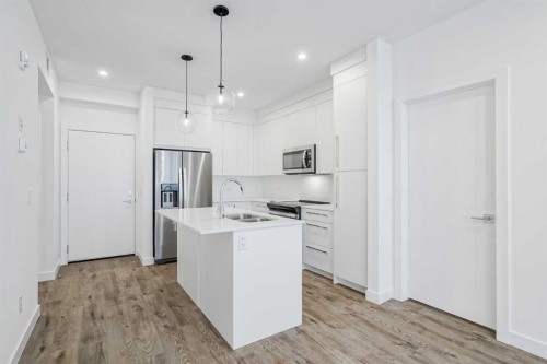 4307-111 Wolf Creek Drive Se, Calgary, AB - Indoor Photo Showing Kitchen With Double Sink With Upgraded Kitchen