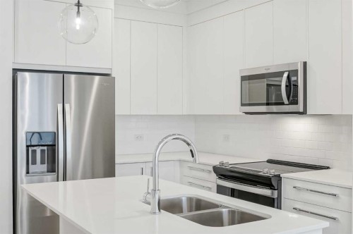 4307-111 Wolf Creek Drive Se, Calgary, AB - Indoor Photo Showing Kitchen With Double Sink With Upgraded Kitchen