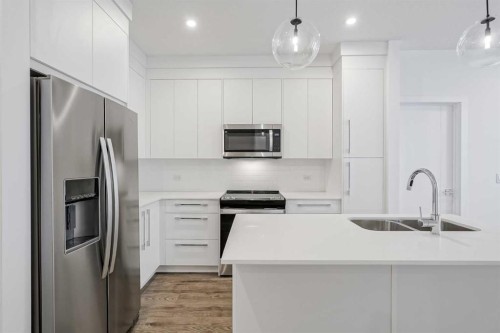4307-111 Wolf Creek Drive Se, Calgary, AB - Indoor Photo Showing Kitchen With Double Sink With Upgraded Kitchen