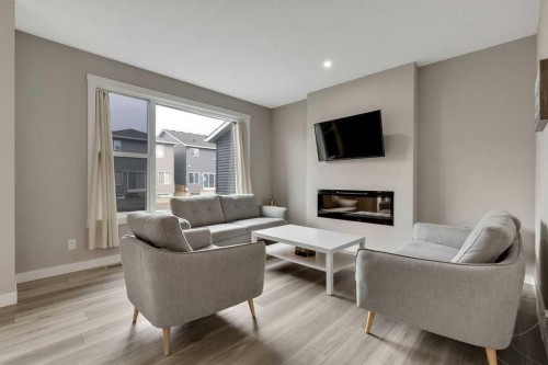 216 Creekstone Row Sw, Calgary, AB - Indoor Photo Showing Living Room With Fireplace