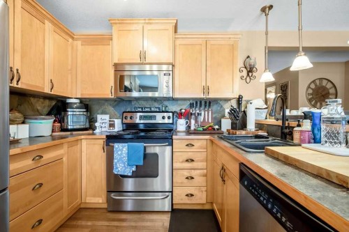 49 Spring Meadows Bay, Okotoks, AB - Indoor Photo Showing Kitchen With Stainless Steel Kitchen With Double Sink