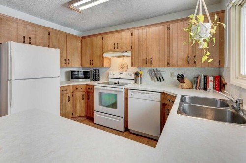 1204 Ranchlands Boulevard Nw, Calgary, AB - Indoor Photo Showing Kitchen With Double Sink