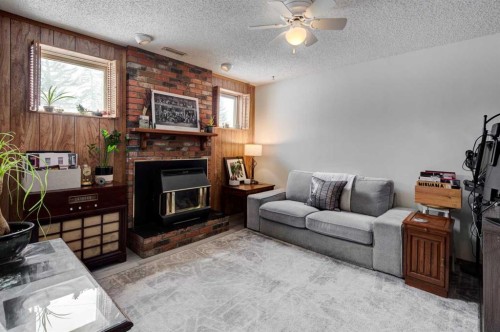 1204 Ranchlands Boulevard Nw, Calgary, AB - Indoor Photo Showing Living Room With Fireplace